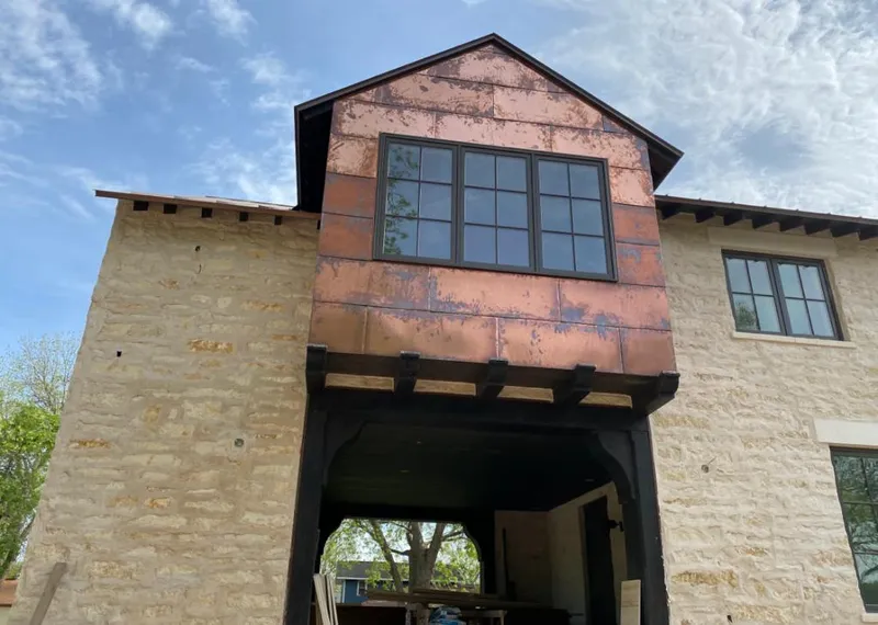 Copper metal panel facade on a stone building for Metal Roof Coating in New Canaan