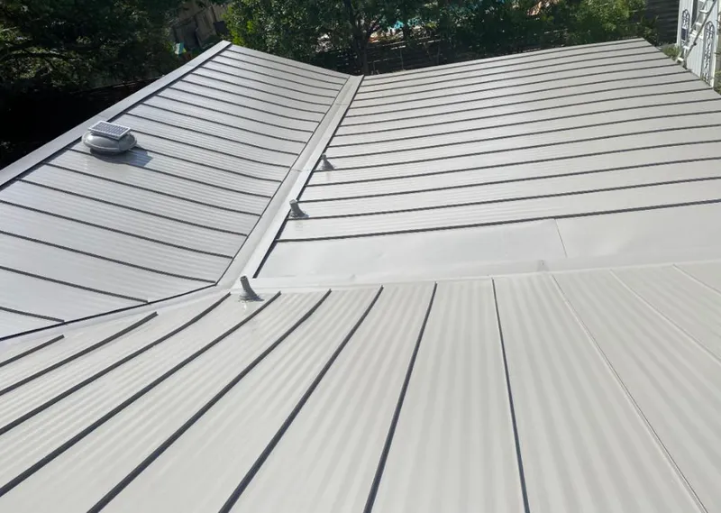 Solar attic fan installed on a metal roof for Roof Ventilation in New Canaan